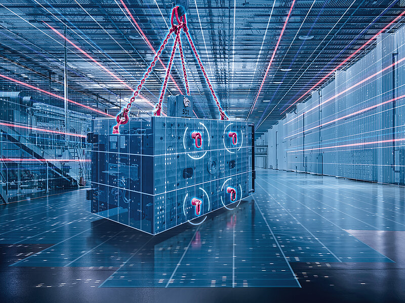 Ein Schwerlastbauteil wird in einer Industriehalle mithilfe eines intelligenten Hebesystems präzise bewegt.